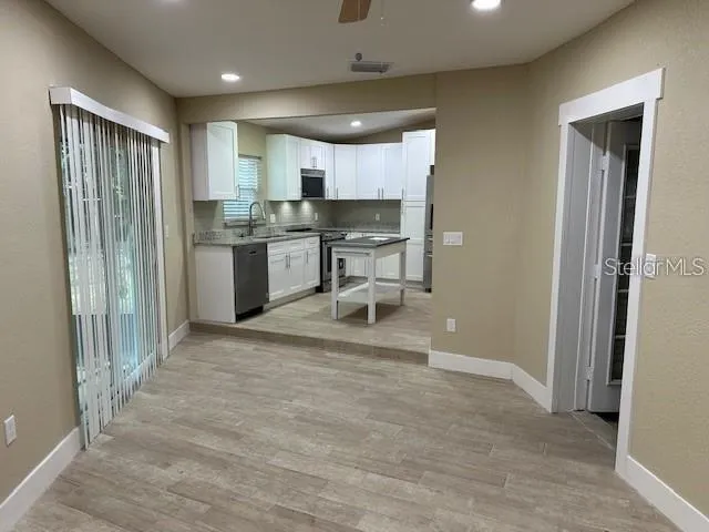 a kitchen with stainless steel appliances a refrigerator and a stove top oven