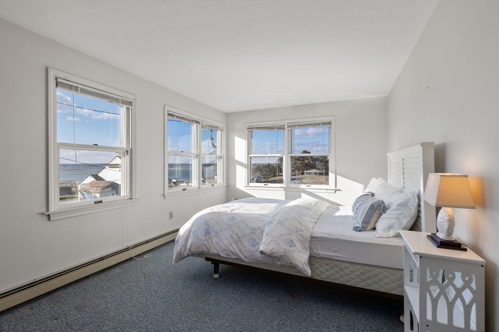 40 Cliff Road South Scituate, MA 02066 - Photo 16 of 30 a bedroom with a bed lamp and window
