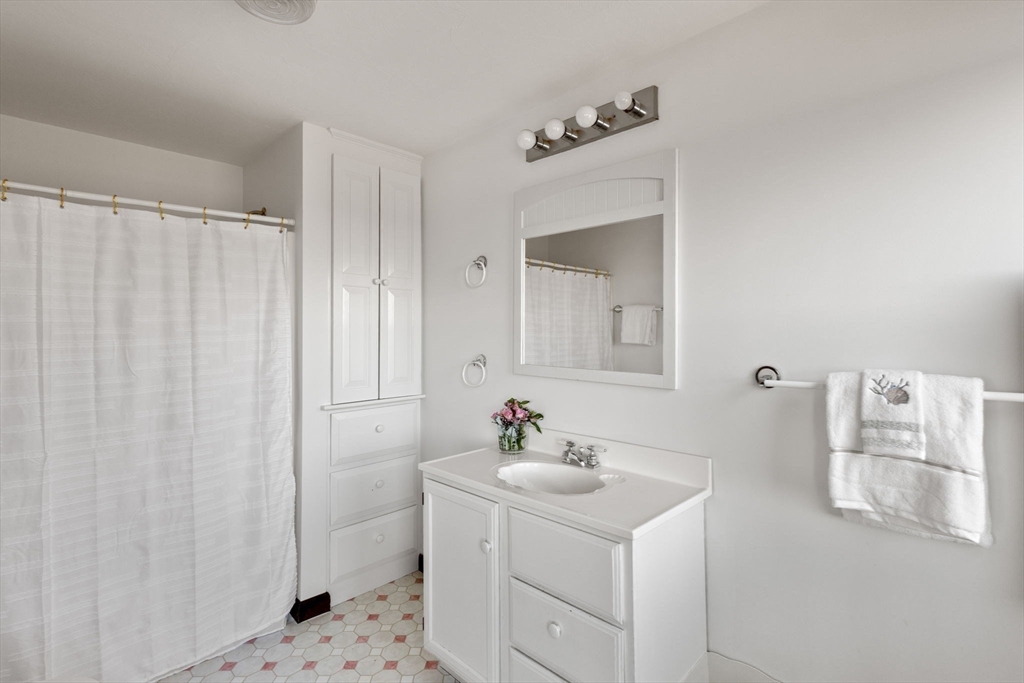 40 Cliff Road South Scituate, MA 02066 - Photo 18 of 30 a bathroom with a sink and a mirror