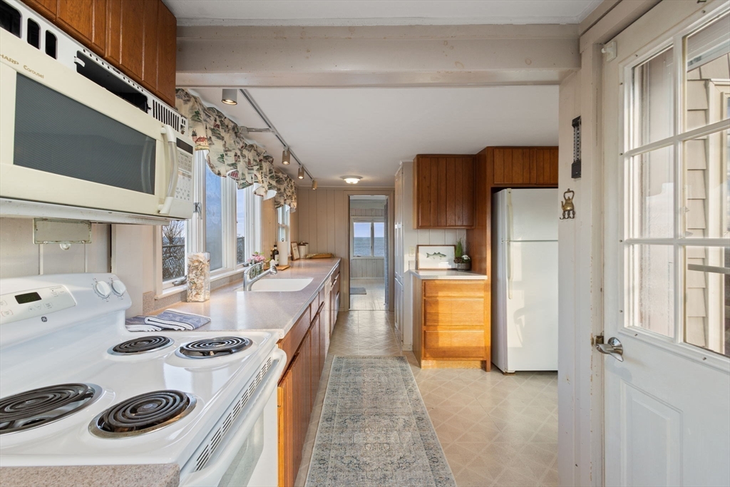 40 Cliff Road South Scituate, MA 02066 - Photo 10 of 30 a kitchen with stainless steel appliances granite countertop a sink a stove a refrigerator and a stove
