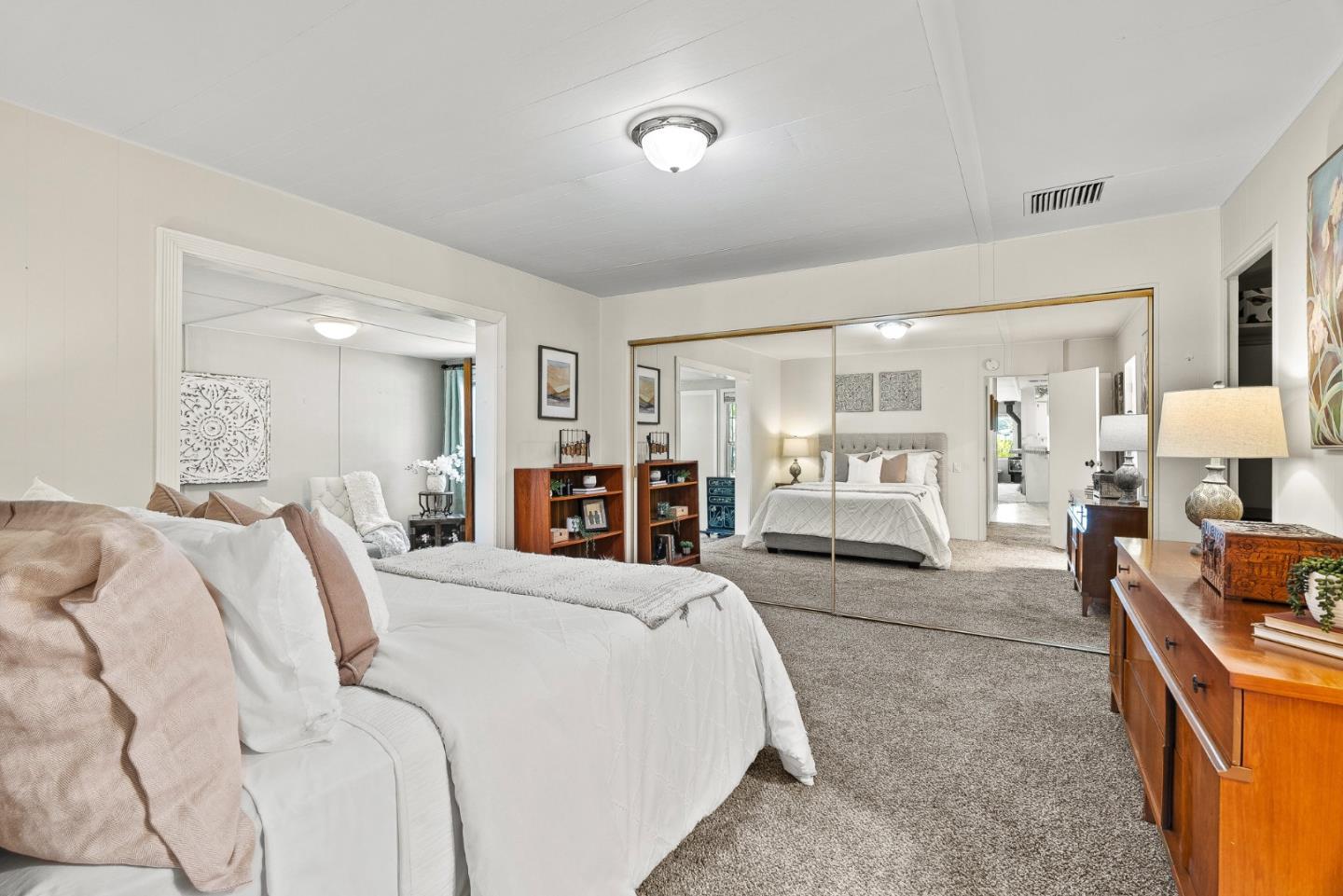 15 Oak Shadows Lane, Unit 15 Aptos, CA 95003 - Photo 15 of 56 a bed room with a bed and a large mirror