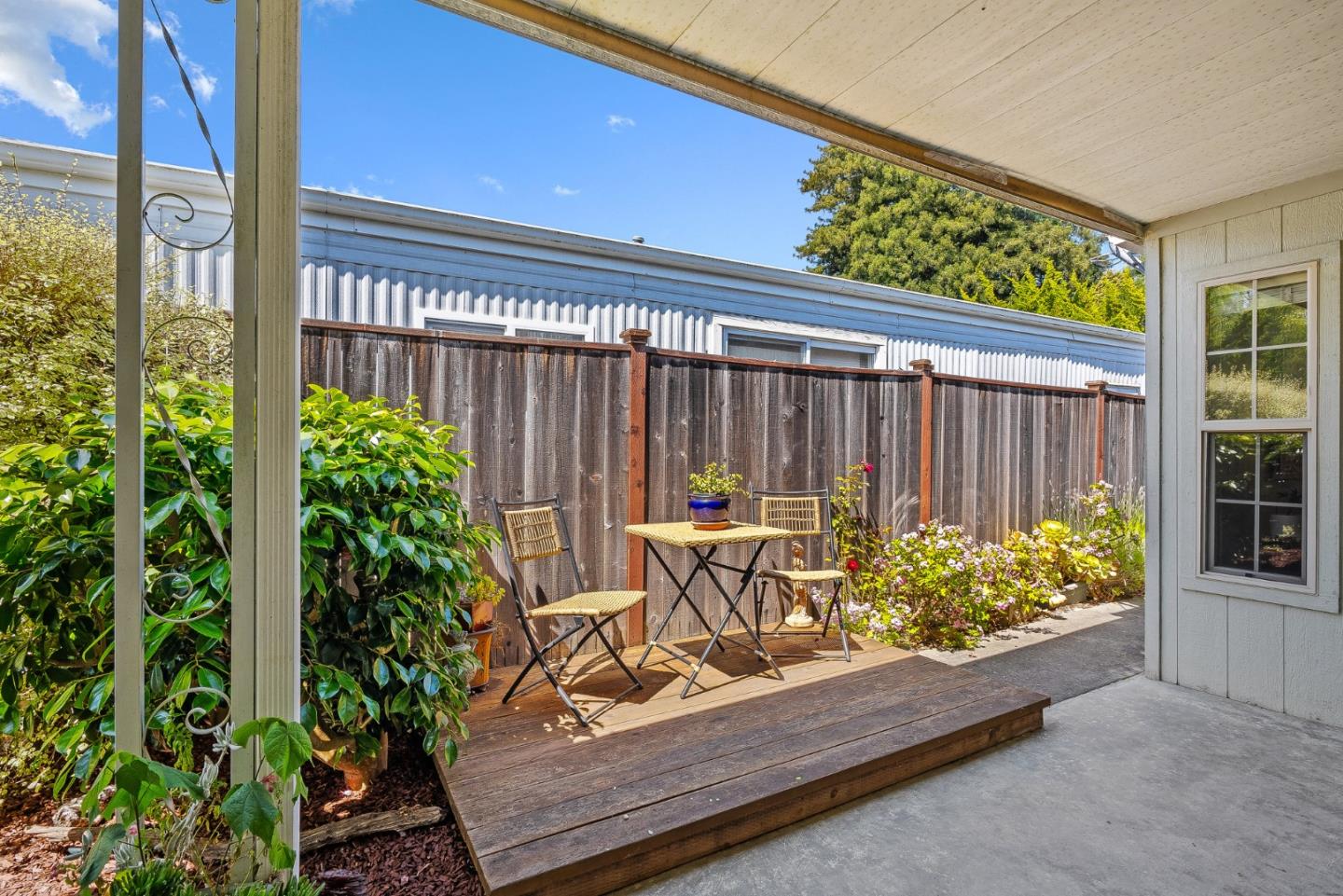 15 Oak Shadows Lane, Unit 15 Aptos, CA 95003 - Photo 25 of 56 a view of a chairs and table in a backyard