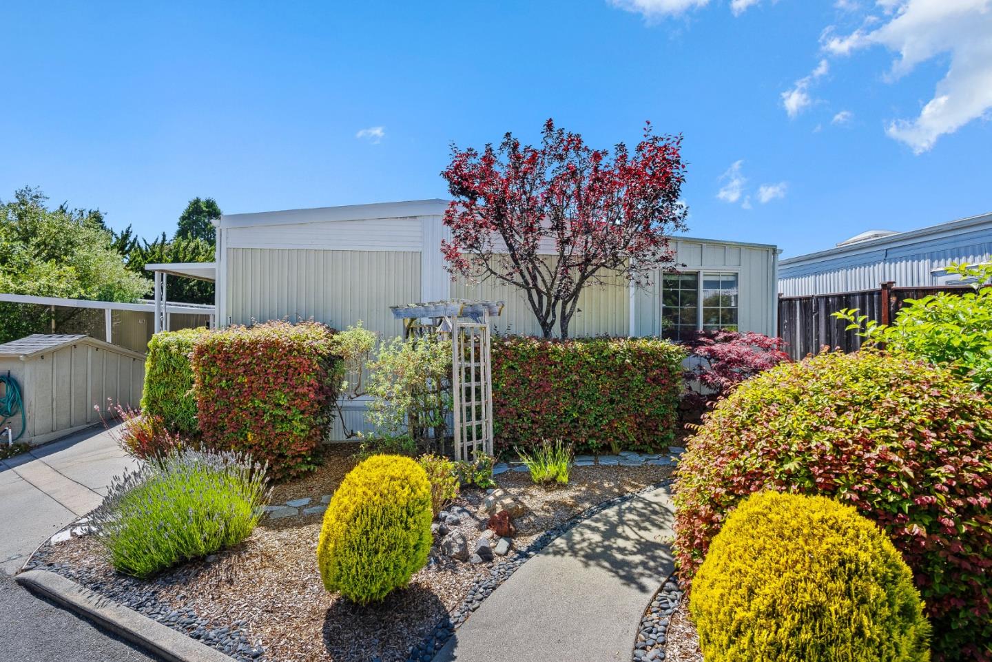 15 Oak Shadows Lane, Unit 15 Aptos, CA 95003 - Photo 27 of 56 a view of a backyard with table and chairs potted plants and large tree