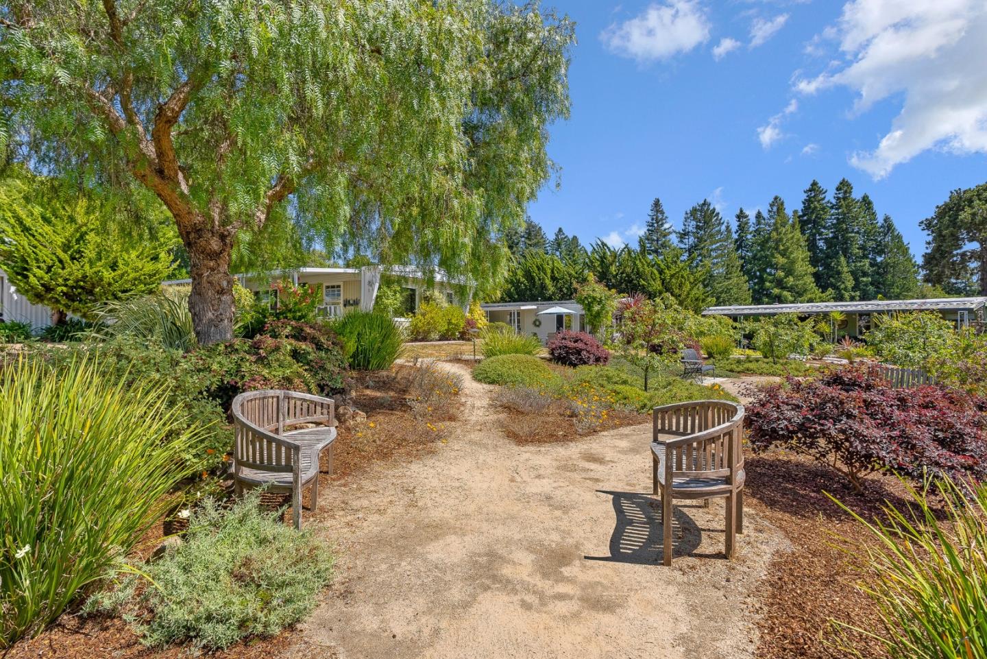 15 Oak Shadows Lane, Unit 15 Aptos, CA 95003 - Photo 30 of 56 a view of a chairs and table in the backyard