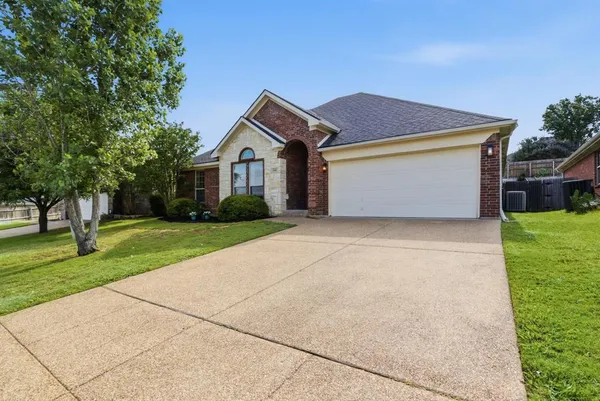 a front view of house with yard and green space
