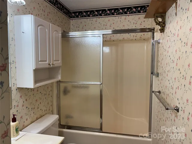 a bathroom with a glass shower door