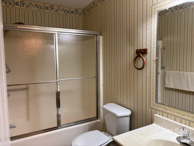 a bathroom with a toilet and a shower
