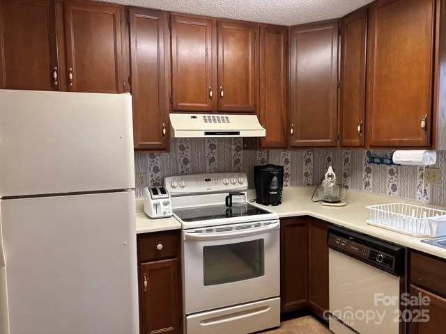 a kitchen with a refrigerator stove and sink