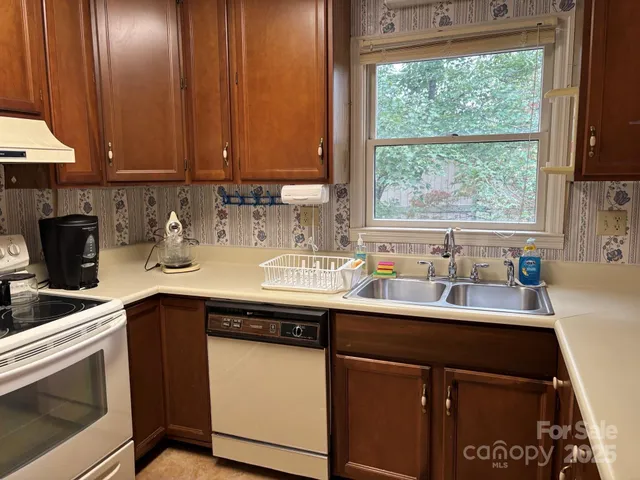 a kitchen with a sink cabinets and window