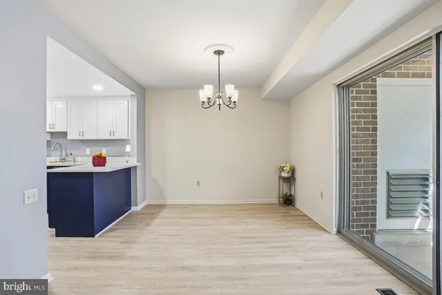 a kitchen view with wooden floor and window