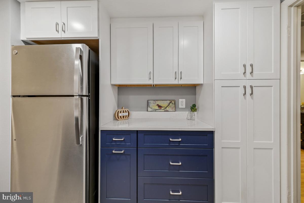 3362 Gleneagles Drive, Unit 711D Silver Spring, MD 20906 - Photo 2 of 26 a white refrigerator freezer sitting in a kitchen