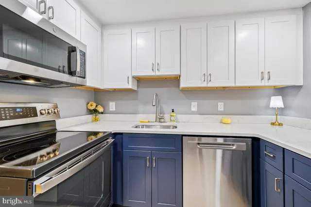 a kitchen with a sink stove and cabinets