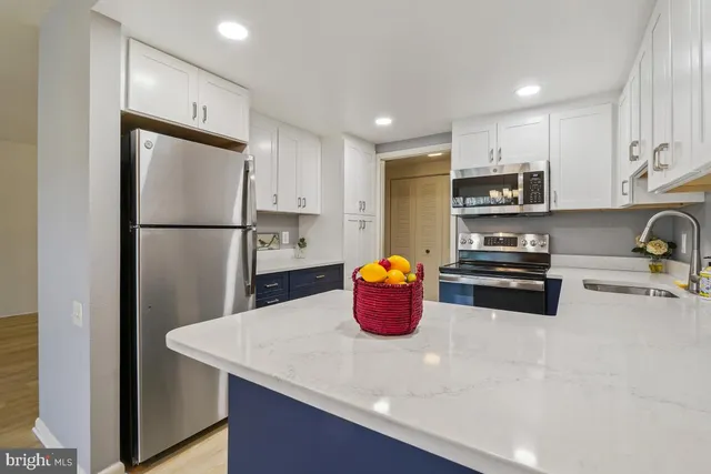 a kitchen with stainless steel appliances a refrigerator and a sink