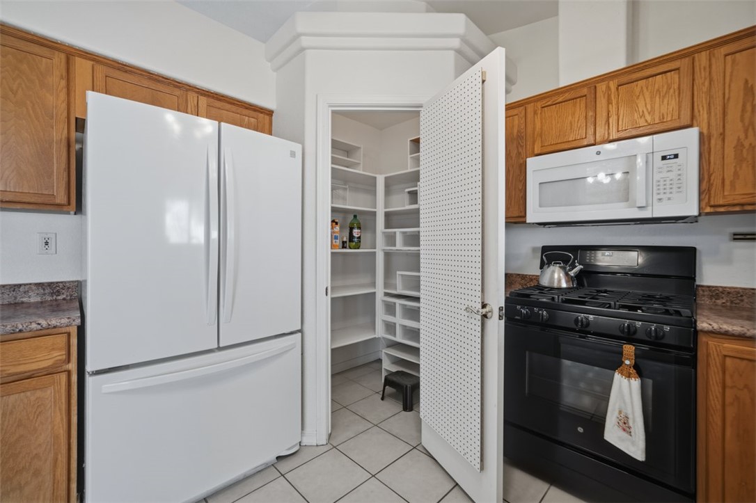 2144 Ridgeview Road Kingman, AZ 86401 - Photo 21 of 49 a kitchen with stainless steel appliances granite countertop white cabinets a refrigerator and a stove