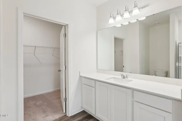a bathroom with a double vanity sink and a mirror