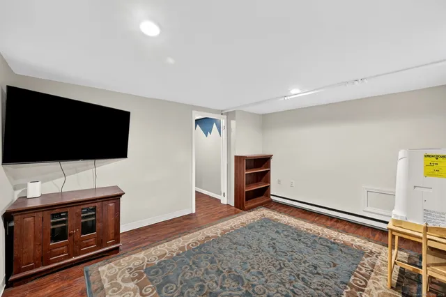 a living room with a flat screen tv and outdoor space