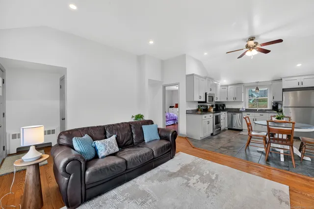 a living room with furniture and kitchen view