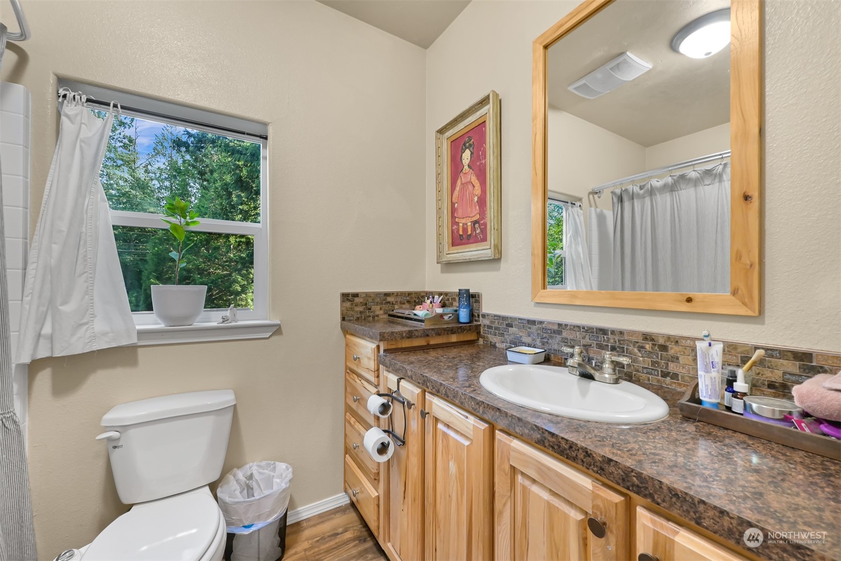 4298 Masterson Road Blaine, WA 98230 - Photo 13 of 31 a bathroom with a granite countertop sink mirror vanity and a toilet