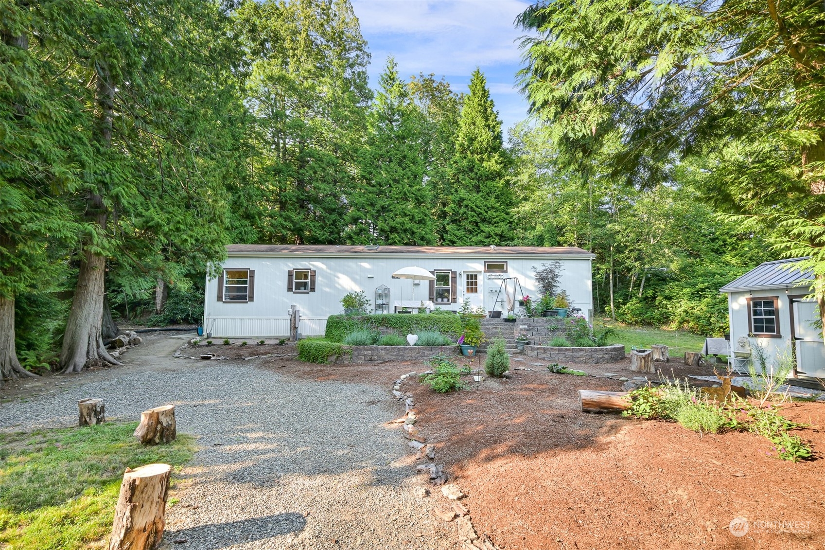 4298 Masterson Road Blaine, WA 98230 - Photo 22 of 31 a view of backyard of house with outdoor seating and trees