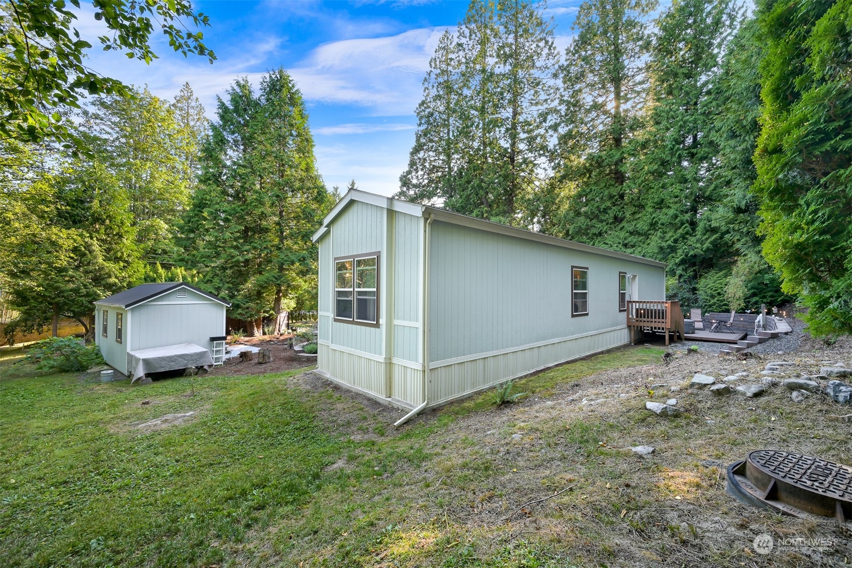 4298 Masterson Road Blaine, WA 98230 - Photo 25 of 31 a view of a backyard with a sitting area and slide