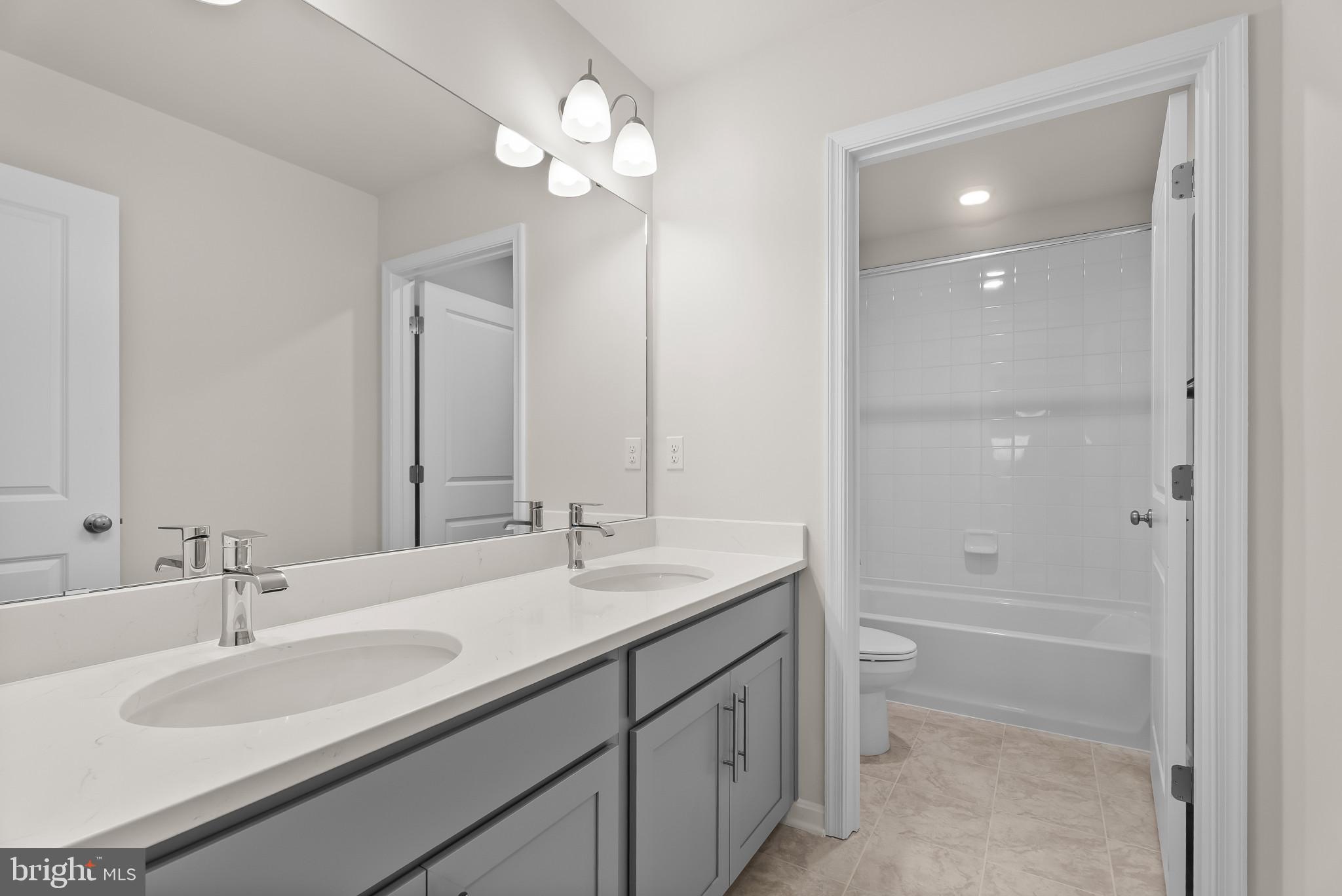 5 Comes Rdg Court Rosedale, MD 21237 - Photo 24 of 48 a bathroom with a sink double vanity and a mirror