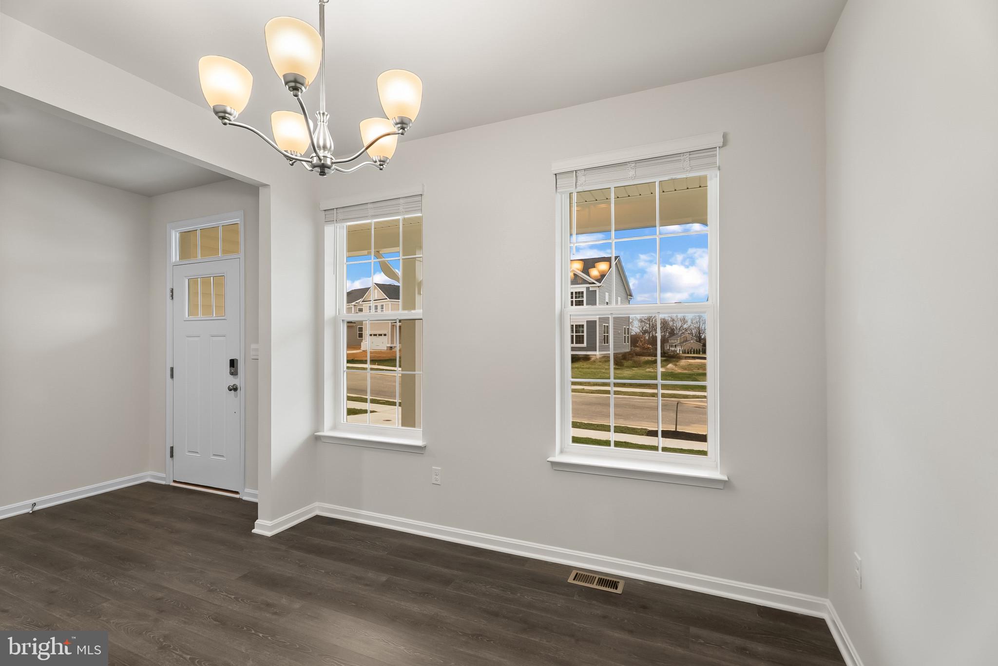 5 Comes Rdg Court Rosedale, MD 21237 - Photo 4 of 48 a view of an empty room with wooden floor and a window