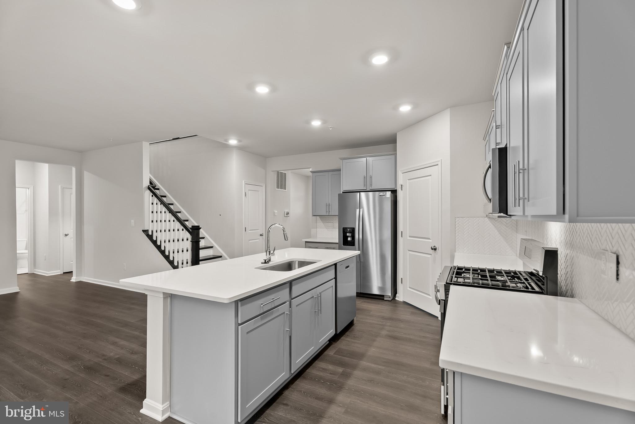 5 Comes Rdg Court Rosedale, MD 21237 - Photo 8 of 48 a large white kitchen with a refrigerator a sink and a stove