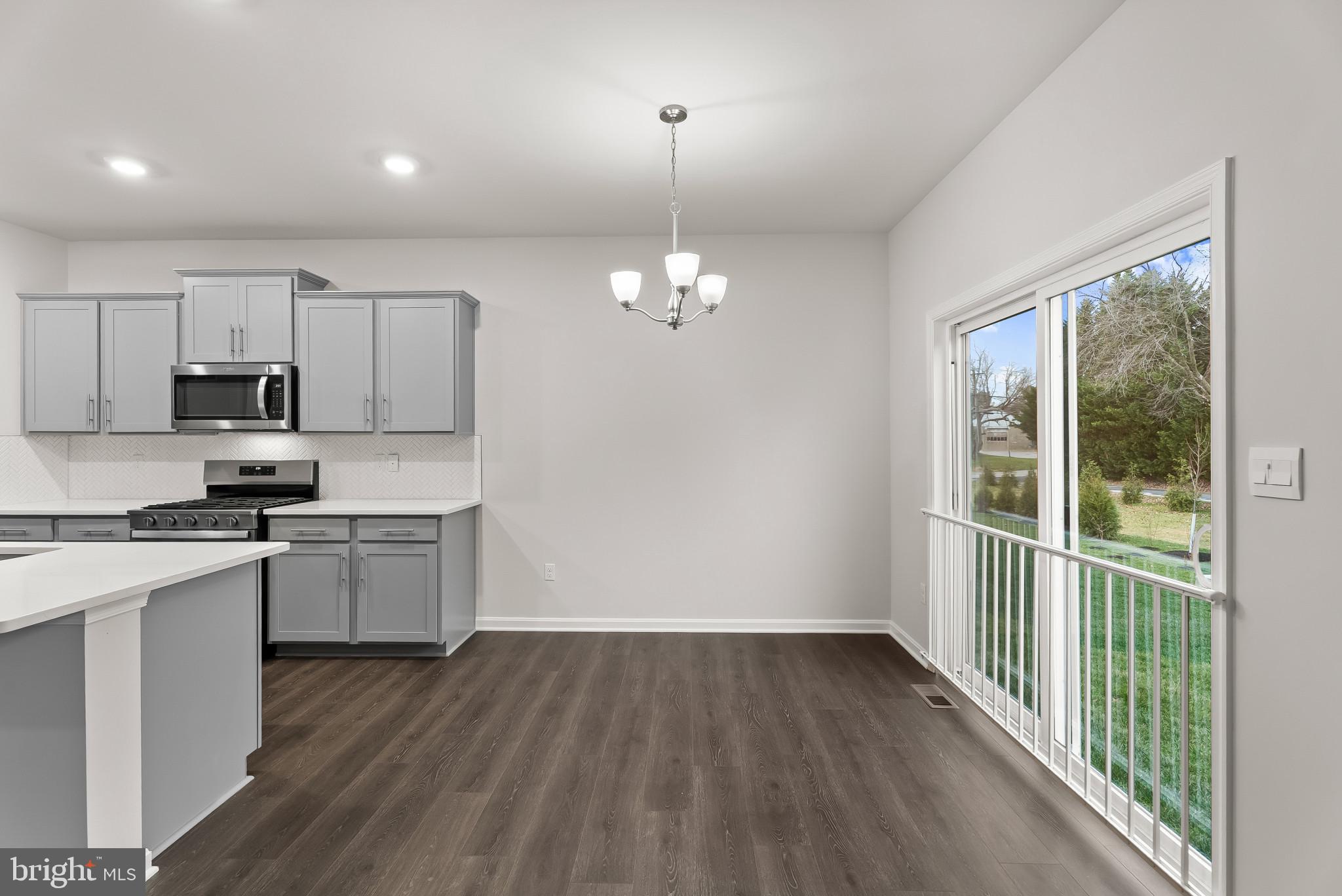 5 Comes Rdg Court Rosedale, MD 21237 - Photo 10 of 48 a kitchen with cabinets wooden floor and a fireplace