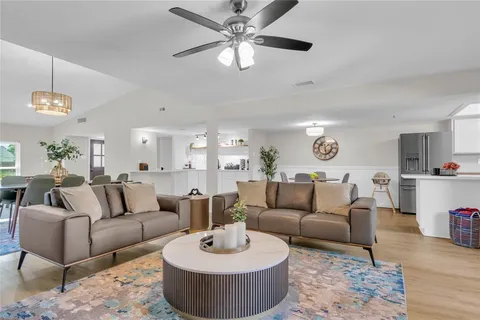 a living room with furniture a rug and a chandelier