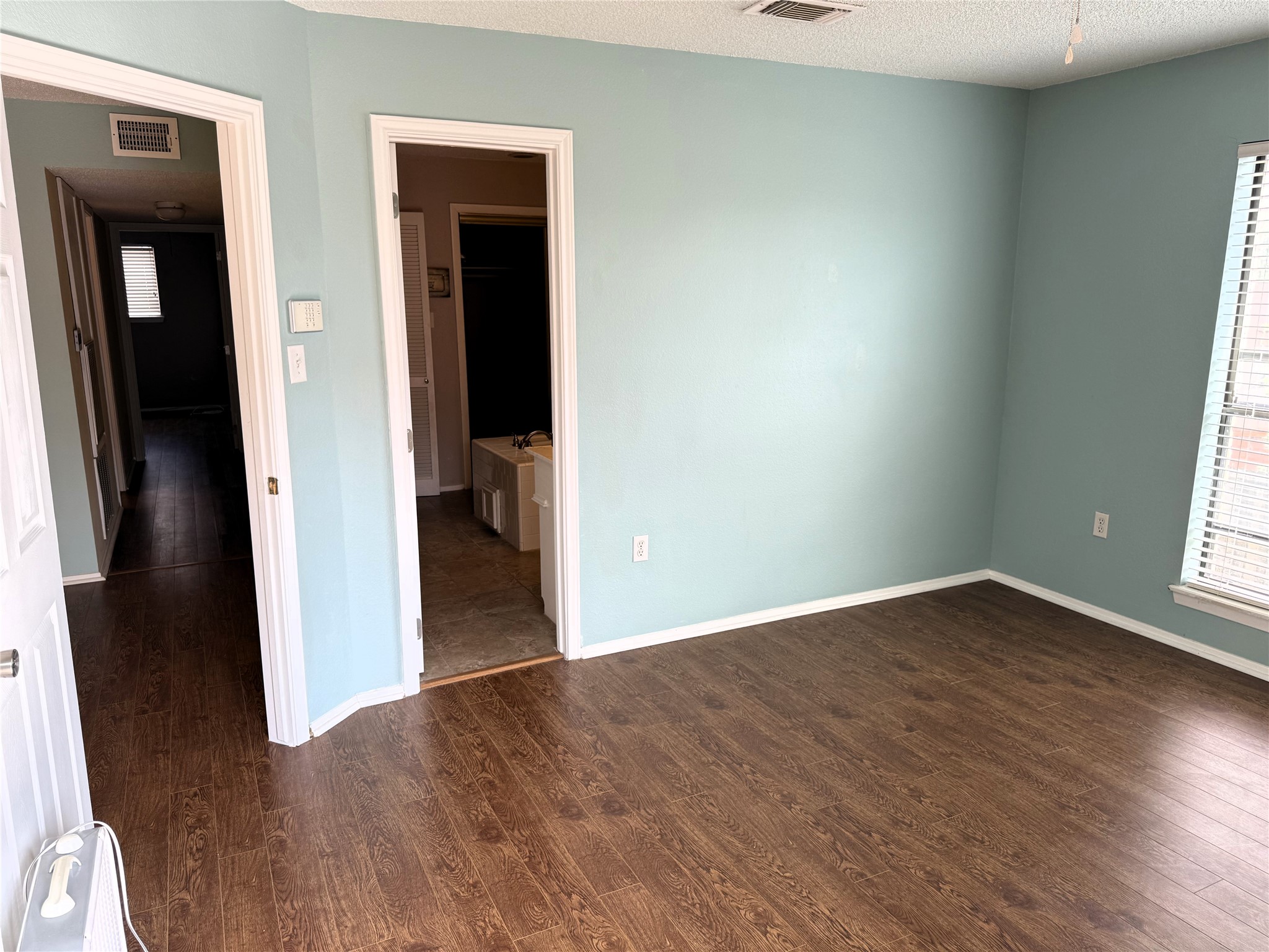 62 Evanston Street, Unit 2/5 Houston, TX 77015 - Photo 12 of 24 an empty room with wooden floor and windows