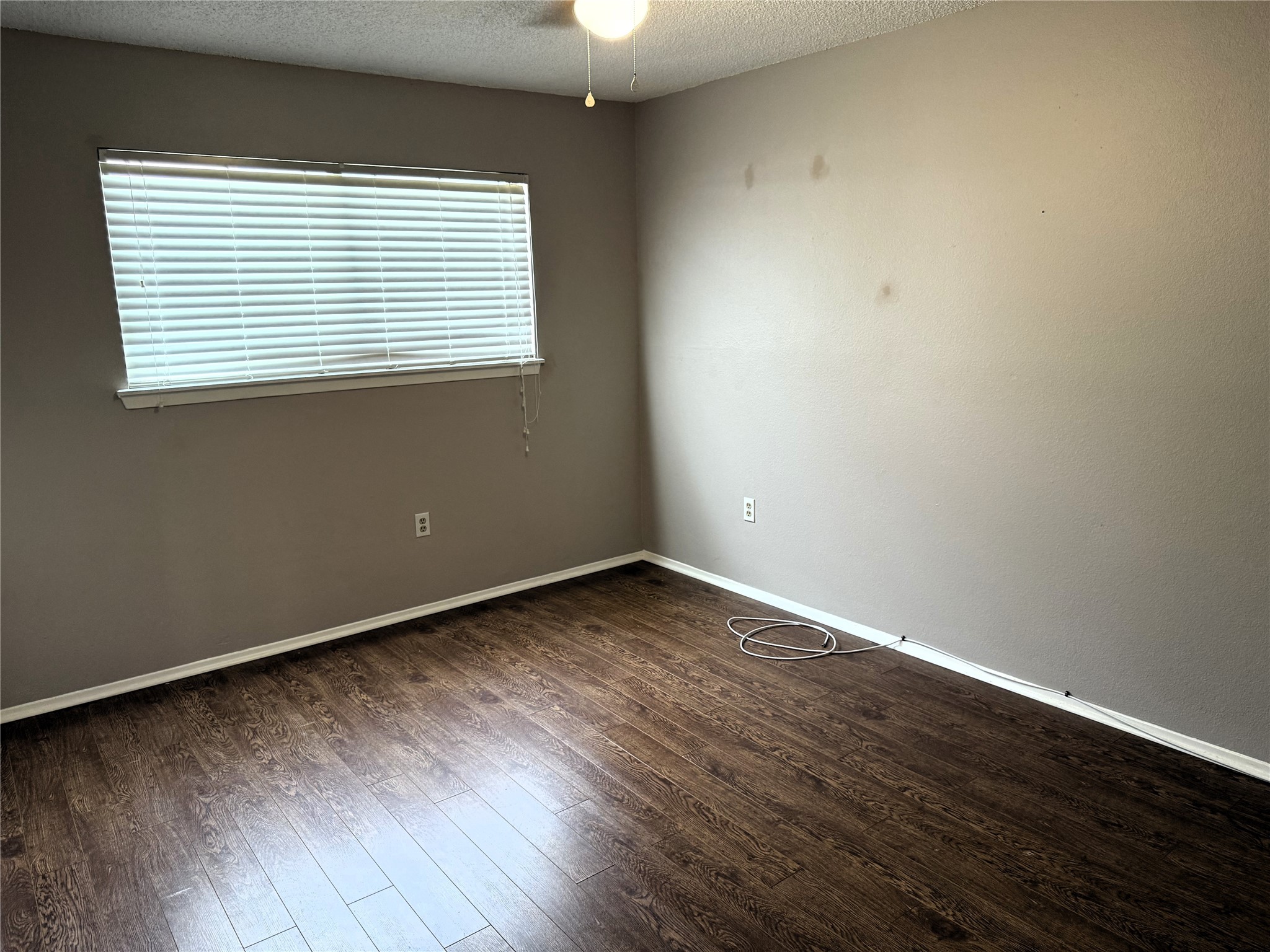 62 Evanston Street, Unit 2/5 Houston, TX 77015 - Photo 20 of 24 an empty room with wooden floor and windows
