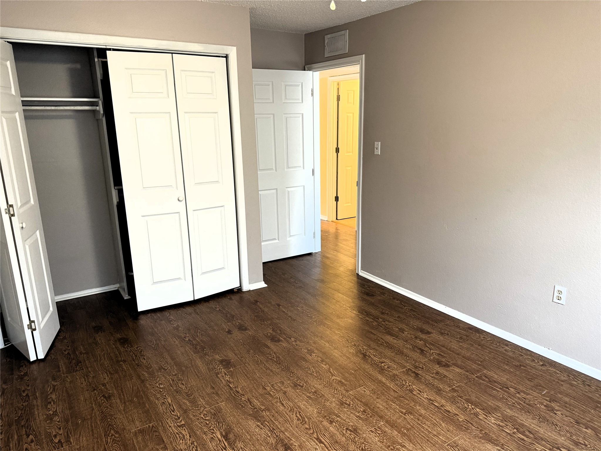 62 Evanston Street, Unit 2/5 Houston, TX 77015 - Photo 21 of 24 a view of an empty room with wooden floor and a window