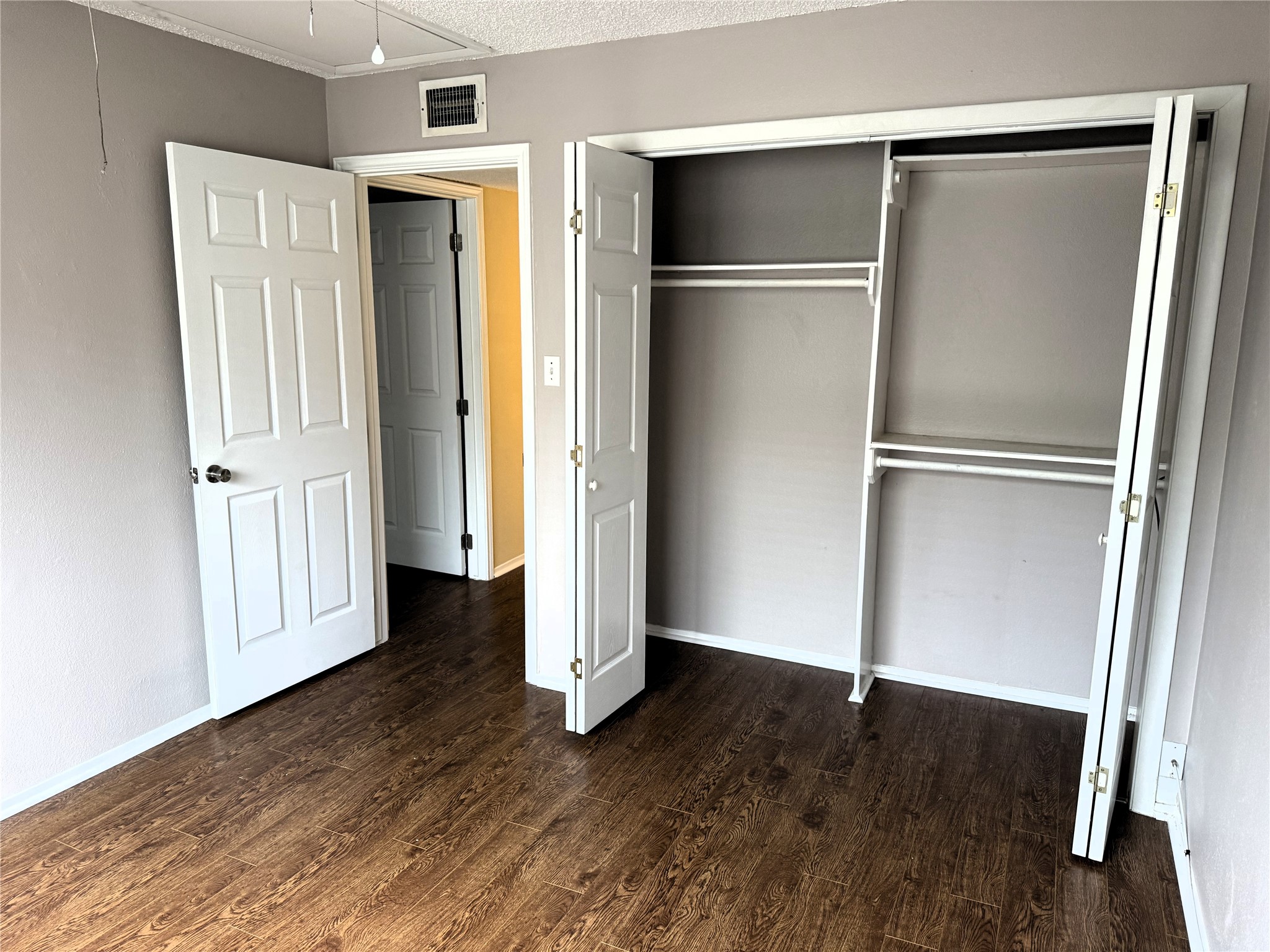 62 Evanston Street, Unit 2/5 Houston, TX 77015 - Photo 23 of 24 a view of an empty room with wooden floor and a window
