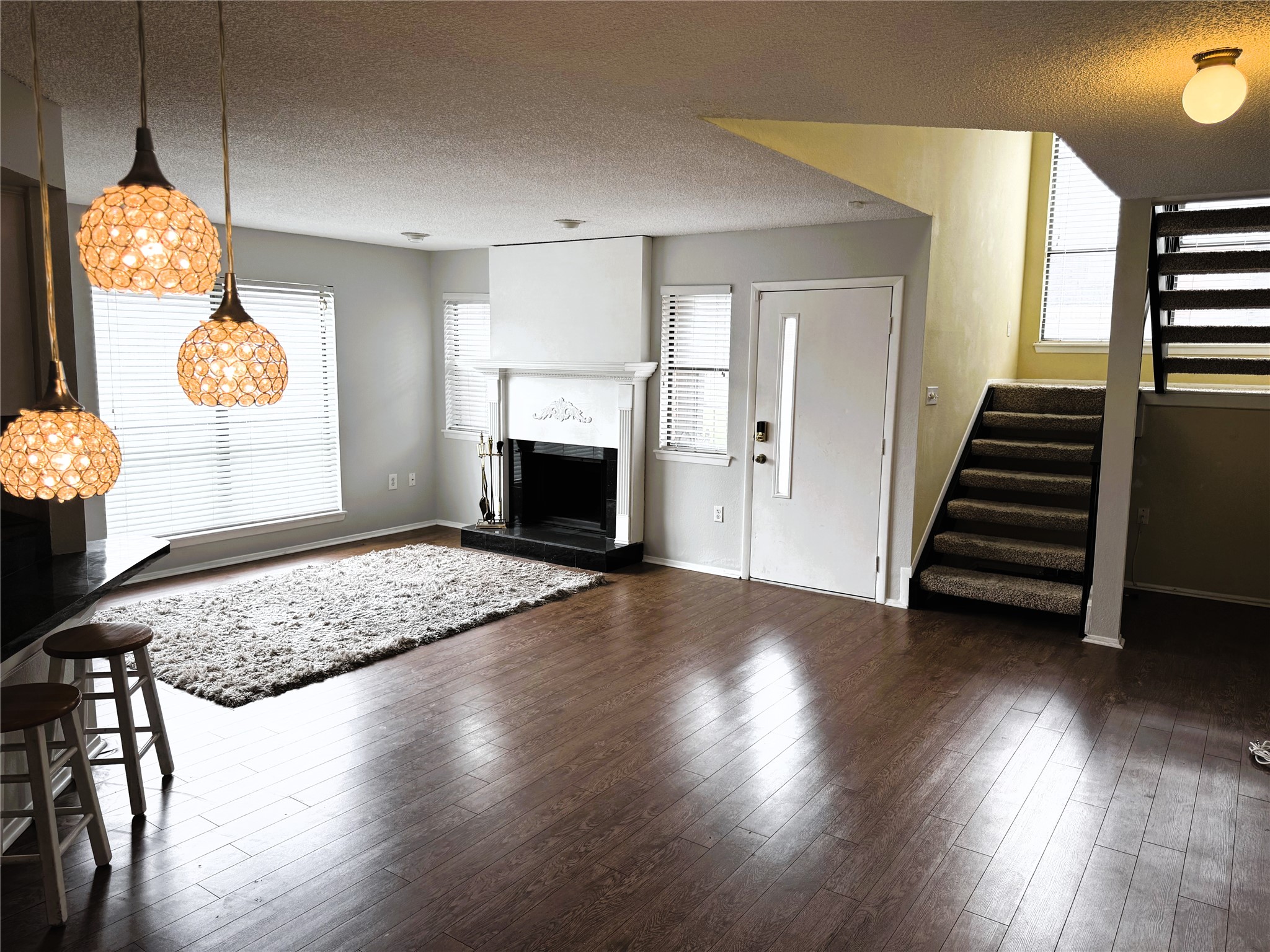 62 Evanston Street, Unit 2/5 Houston, TX 77015 - Photo 4 of 24 a view of an empty room with wooden floor and a fireplace