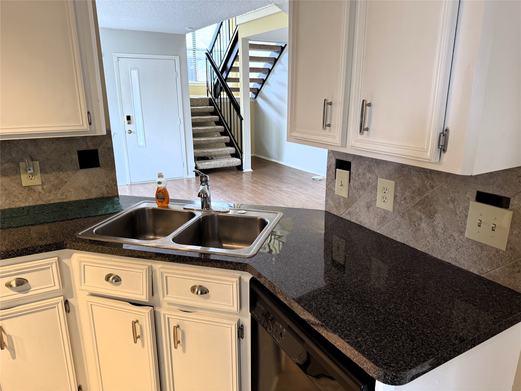 62 Evanston Street, Unit 2/5 Houston, TX 77015 - Photo 6 of 24 a kitchen with granite countertop a sink stove and cabinets