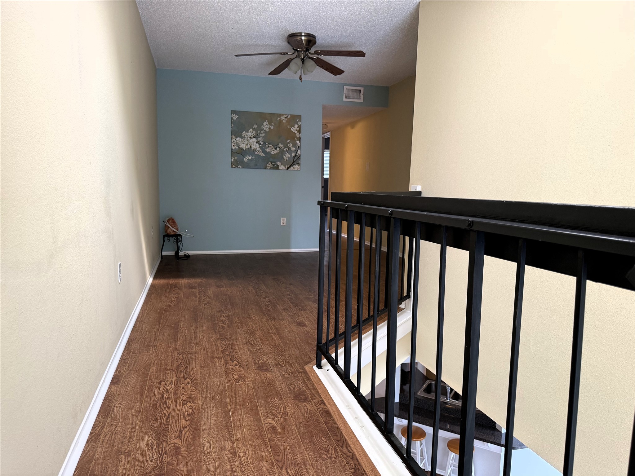 62 Evanston Street, Unit 2/5 Houston, TX 77015 - Photo 9 of 24 a view of a hallway with wooden floor and stairs