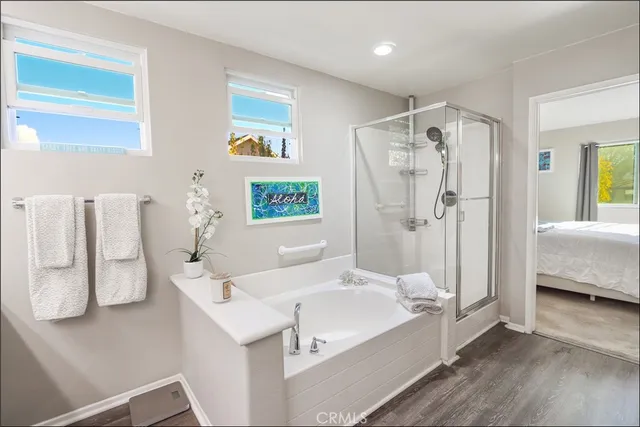 a bathroom with a white tub shower vanity and a sink