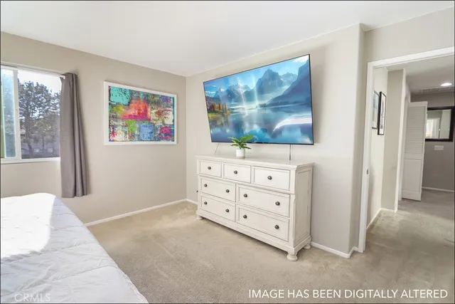 a view of a bedroom with furniture and window