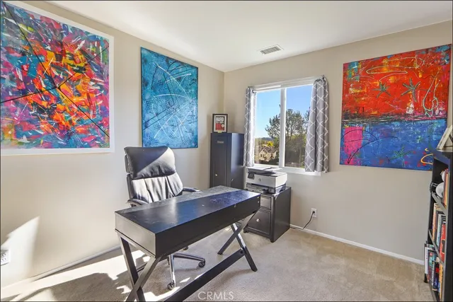 a view of a livingroom with furniture and a window