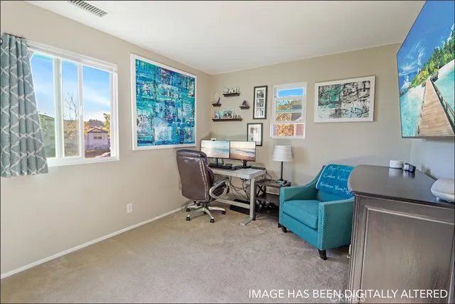 a view of a livingroom with workspace and a window