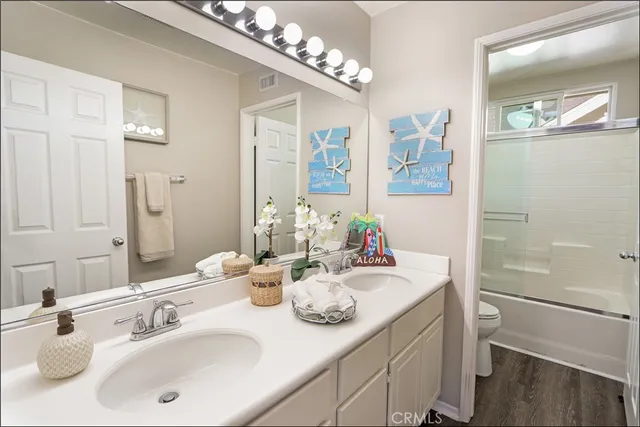 a bathroom with a sink double vanity and a mirror