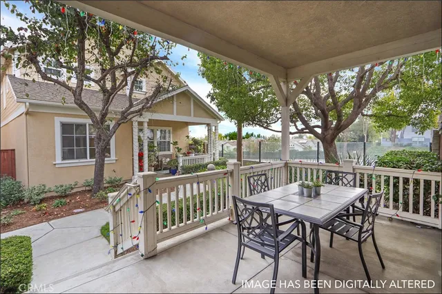 a view of a patio with a table chairs and a backyard