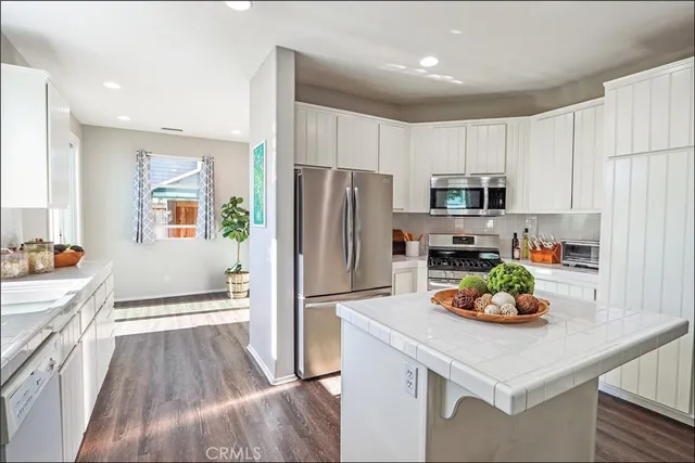 a kitchen with a sink appliances and cabinets
