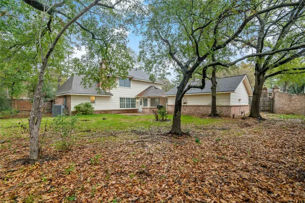 a front view of a house with a yard and trees