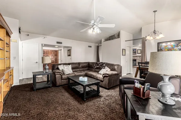 a living room with furniture and wooden floor
