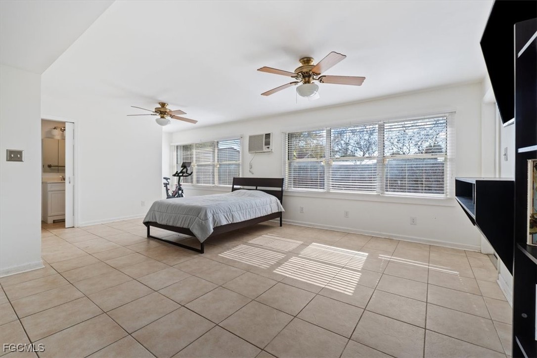 610 East Avenida Del Rio Clewiston, FL 33440 - Photo 22 of 49 a bedroom with a large bed and a flat tv screen on dresser