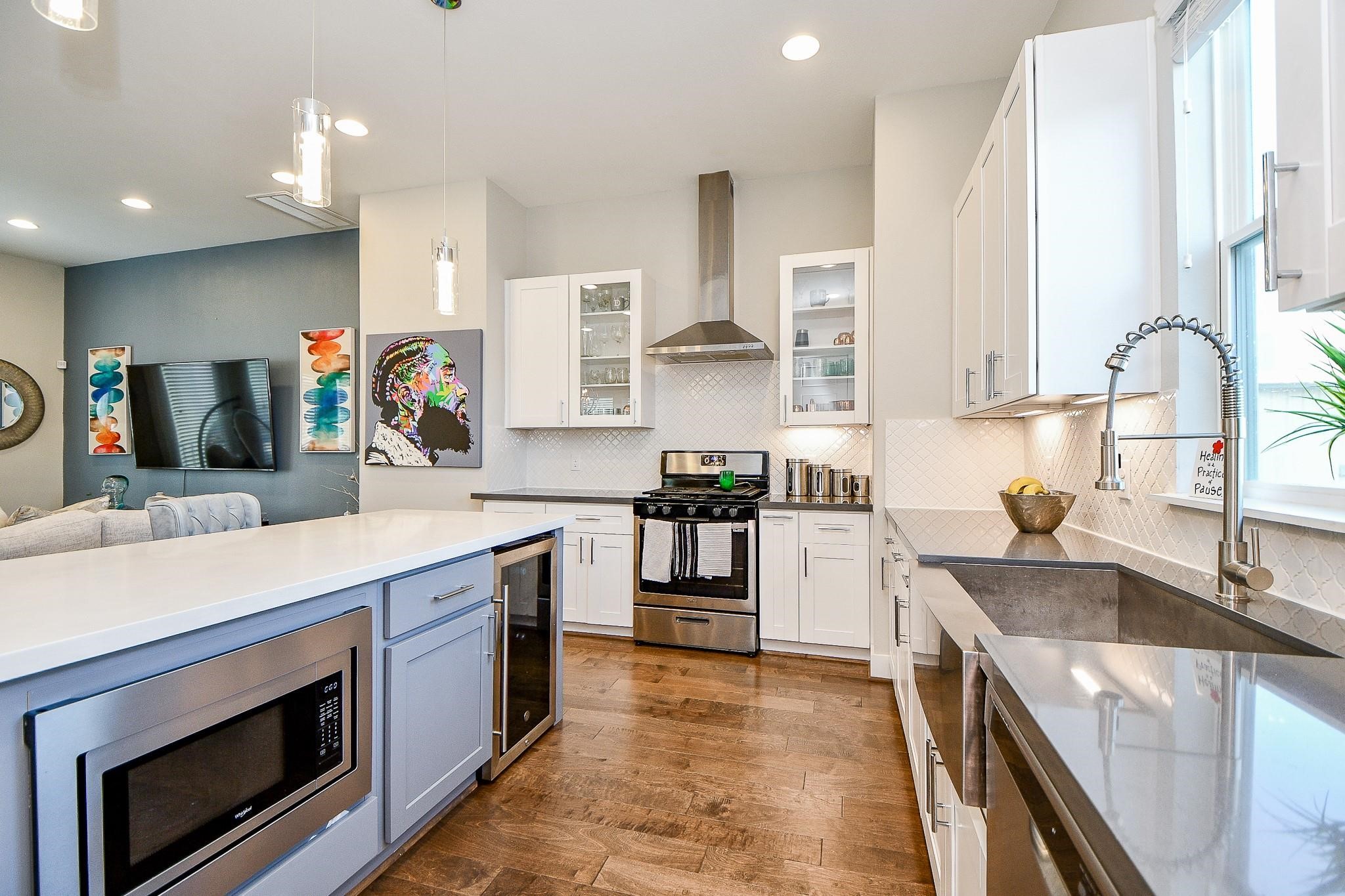 2010 St Charles Street Houston, TX 77003 - Photo 12 of 44 a kitchen with stainless steel appliances granite countertop a sink stove and refrigerator