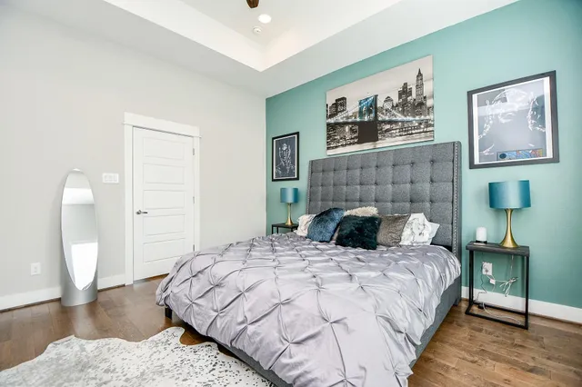 a bedroom with a bed and a lamp on dresser