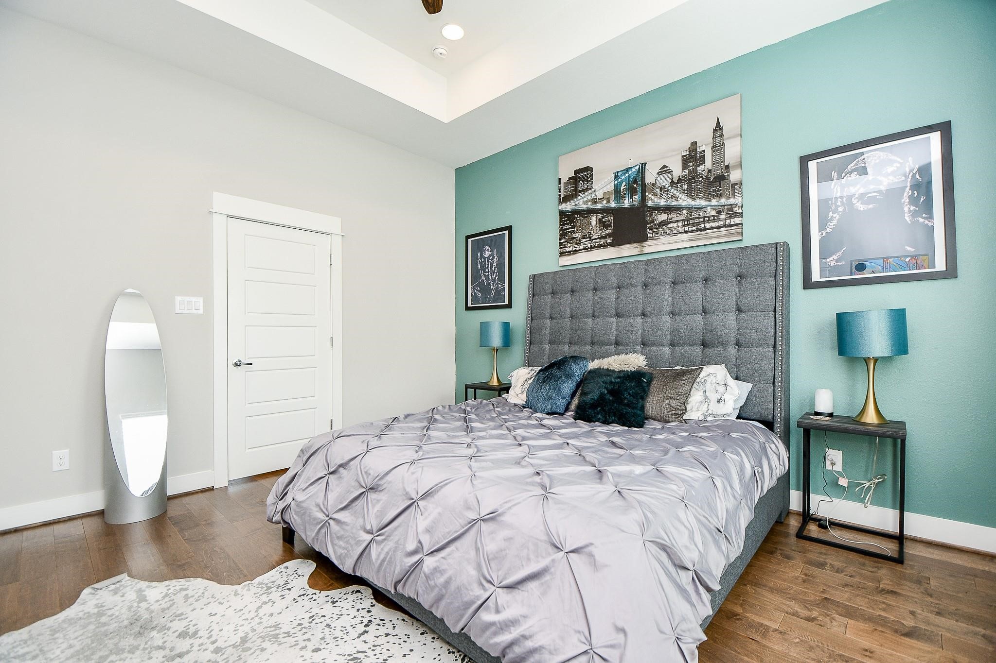 2010 St Charles Street Houston, TX 77003 - Photo 17 of 44 a bedroom with a bed and a lamp on dresser