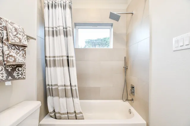 a bathroom with a bathtub and a shower